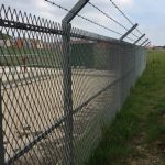 Mesh Panel Fencing Topped With Barbed Wire